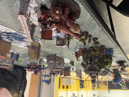 An Ork warboss on a beast leads the charge