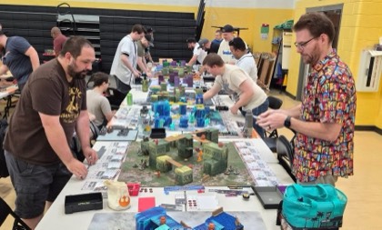 Players around a colourful terrain table at Smite Club Open 2026