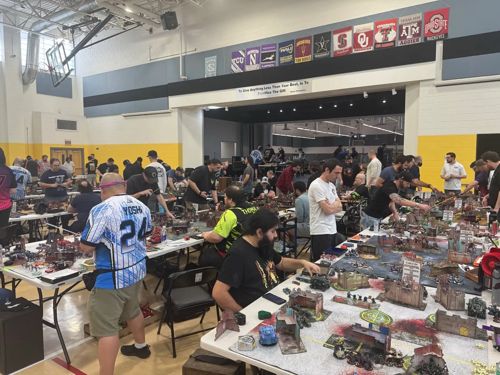 Players compete across a busy tournament floor at Scorched Earth Open